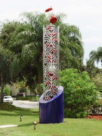 Tower with blue base, column with heart designs and red and white objects inside column